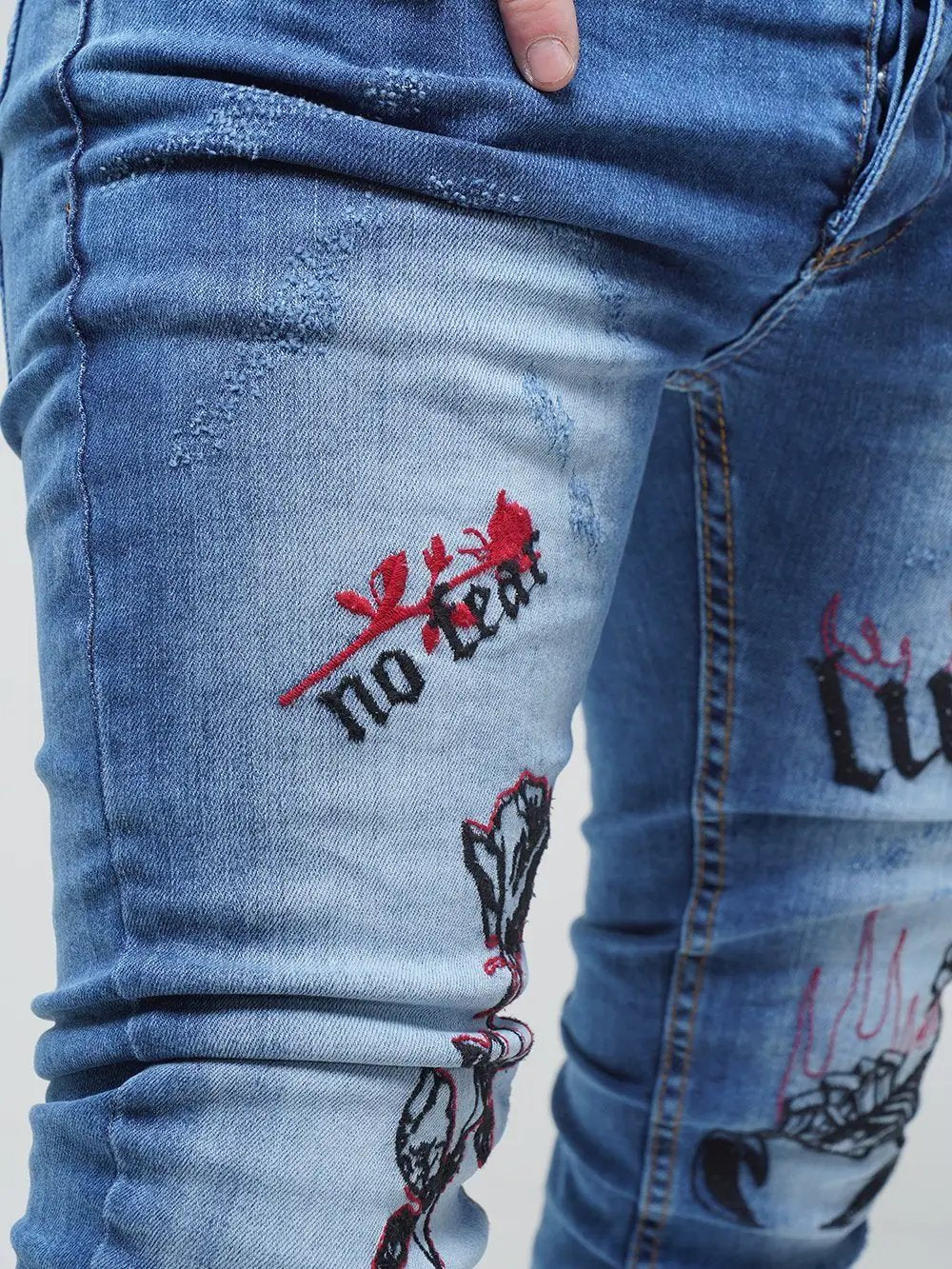 Lower body shot of a man wearing ROSE TATTOO skinny jeans