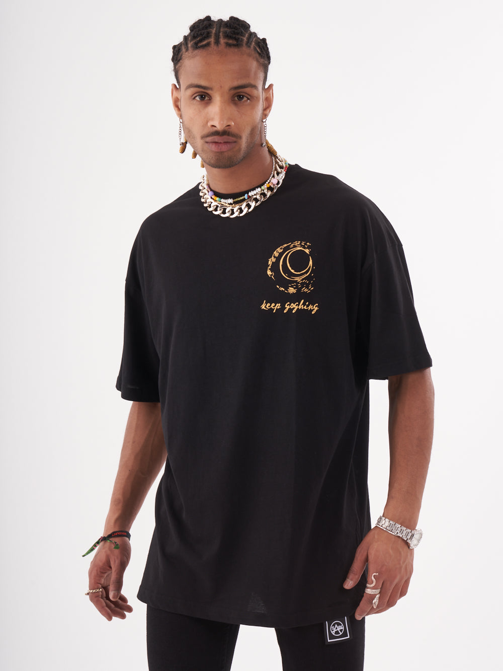 A man wearing a VINCENT T-SHIRT with gold lettering.