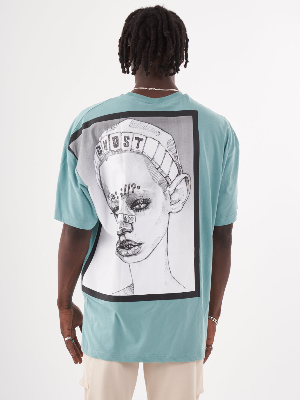 The back of a man wearing a GHOST T-SHIRT with a drawing on it.