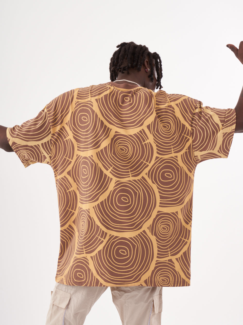 A man wearing a STEPPE T-SHIRT with a pattern on it.