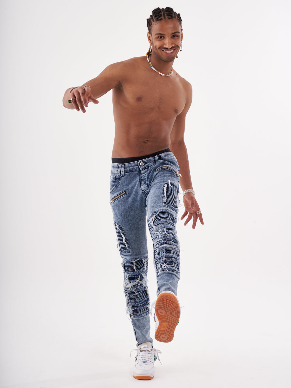 A man in RADICAL jeans is posing for a photo.