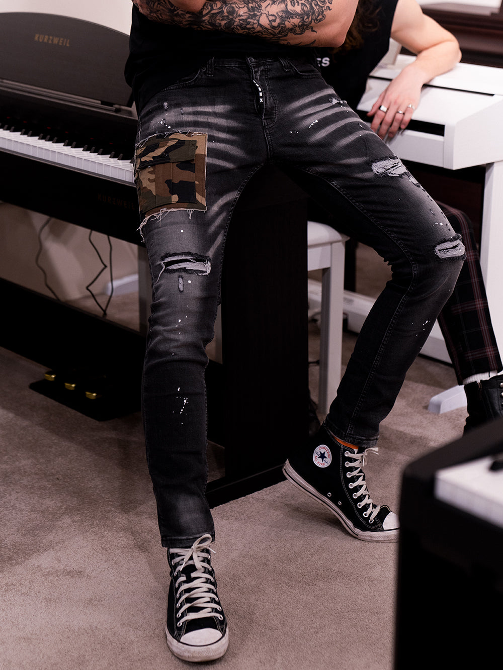 A man sitting on a CAMOUFLAGE | BLACK.