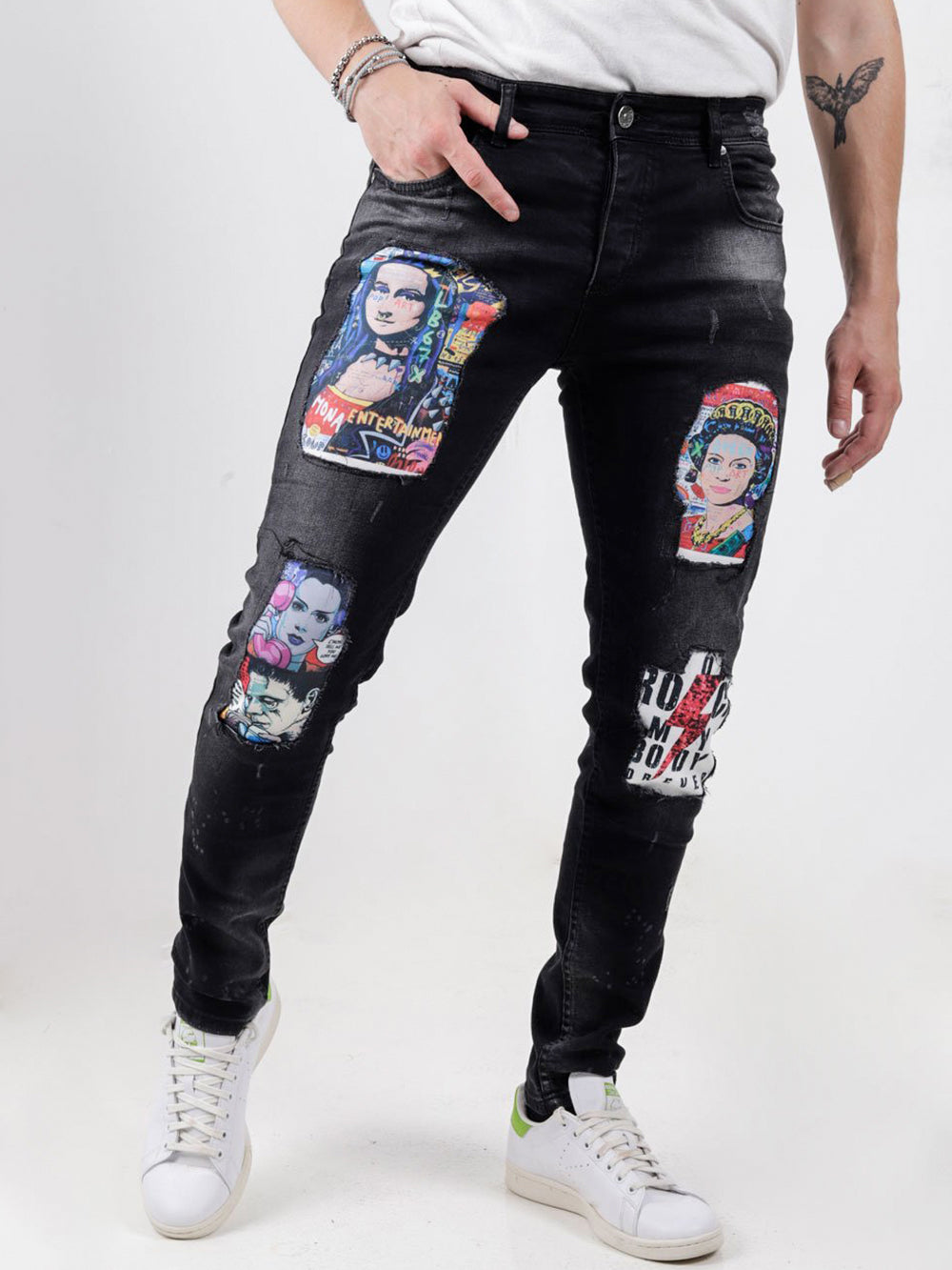 A man wearing a pair of MOONLISA jeans with patches on them.