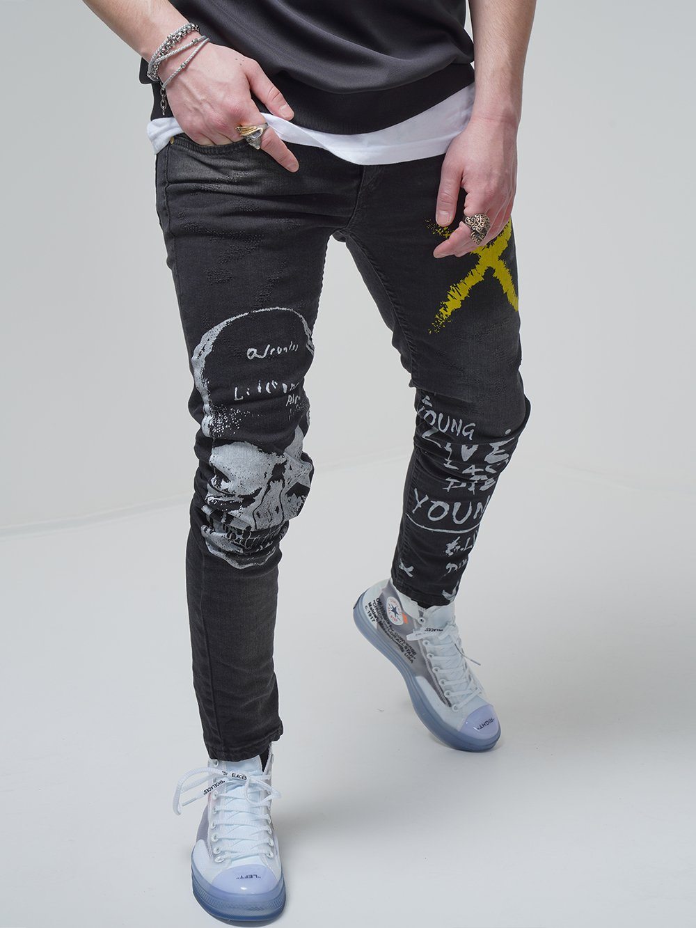 A man wearing DEAN jeans and a yellow t - shirt.