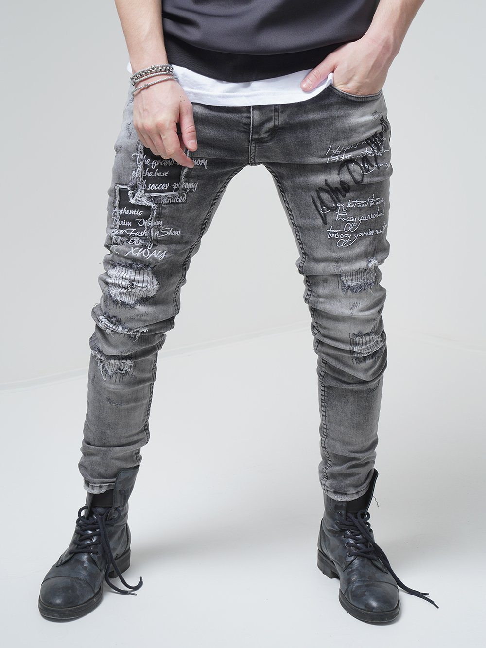 A man sporting LONDON skinny-fit ripped jeans as part of his streetwear-inspired outfit.