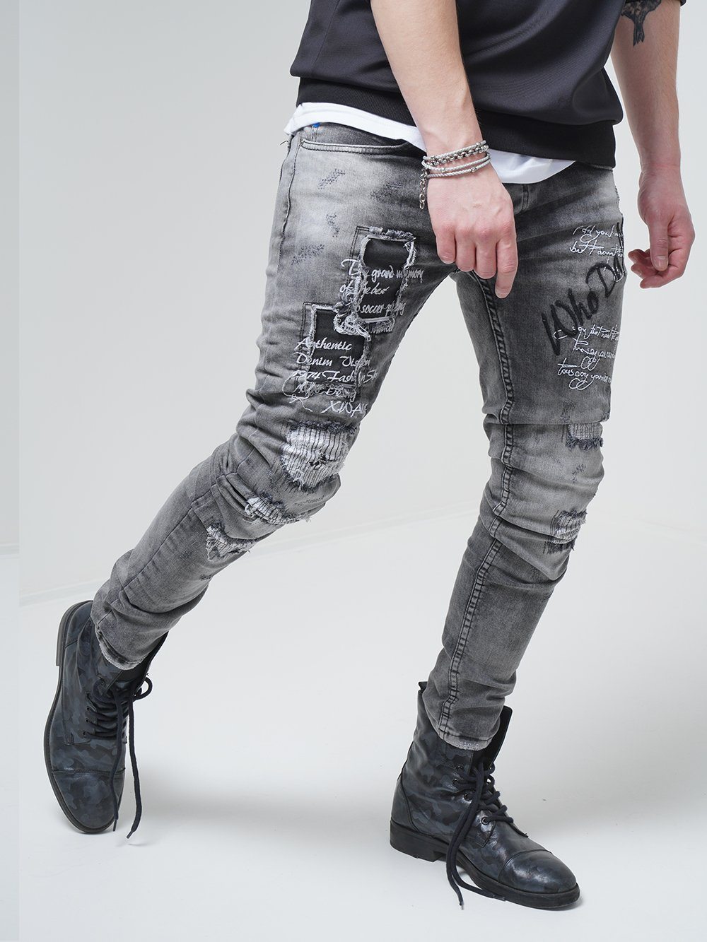 A man wearing LONDON skinny fit ripped jeans.