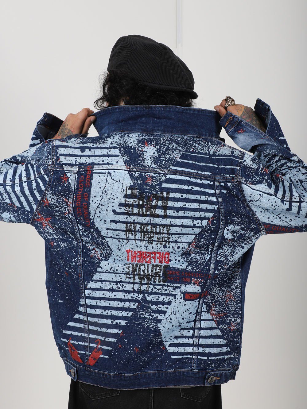 The back of a man wearing a CRAZY CAT denim jacket.