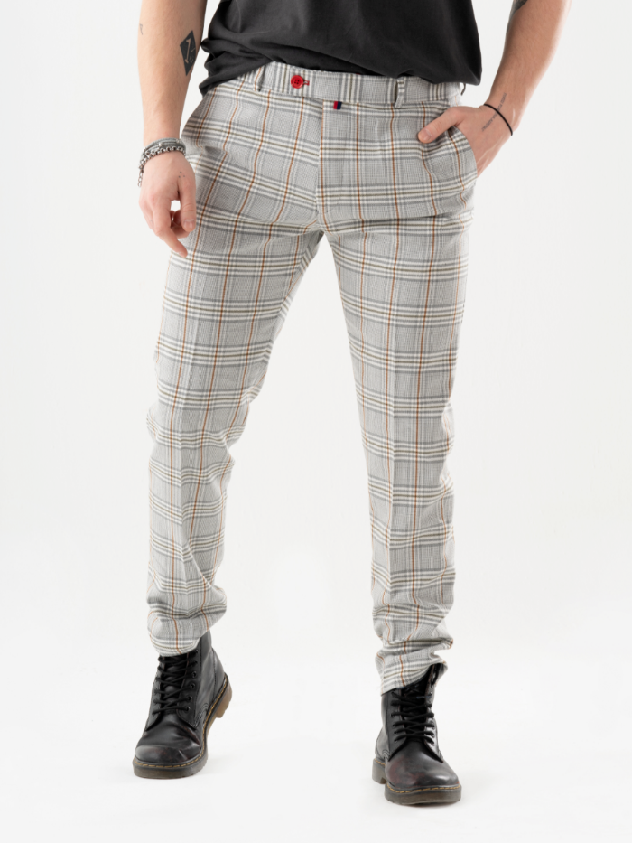 A man in a plaid shirt and ALORA PANTS is posing for a photo.