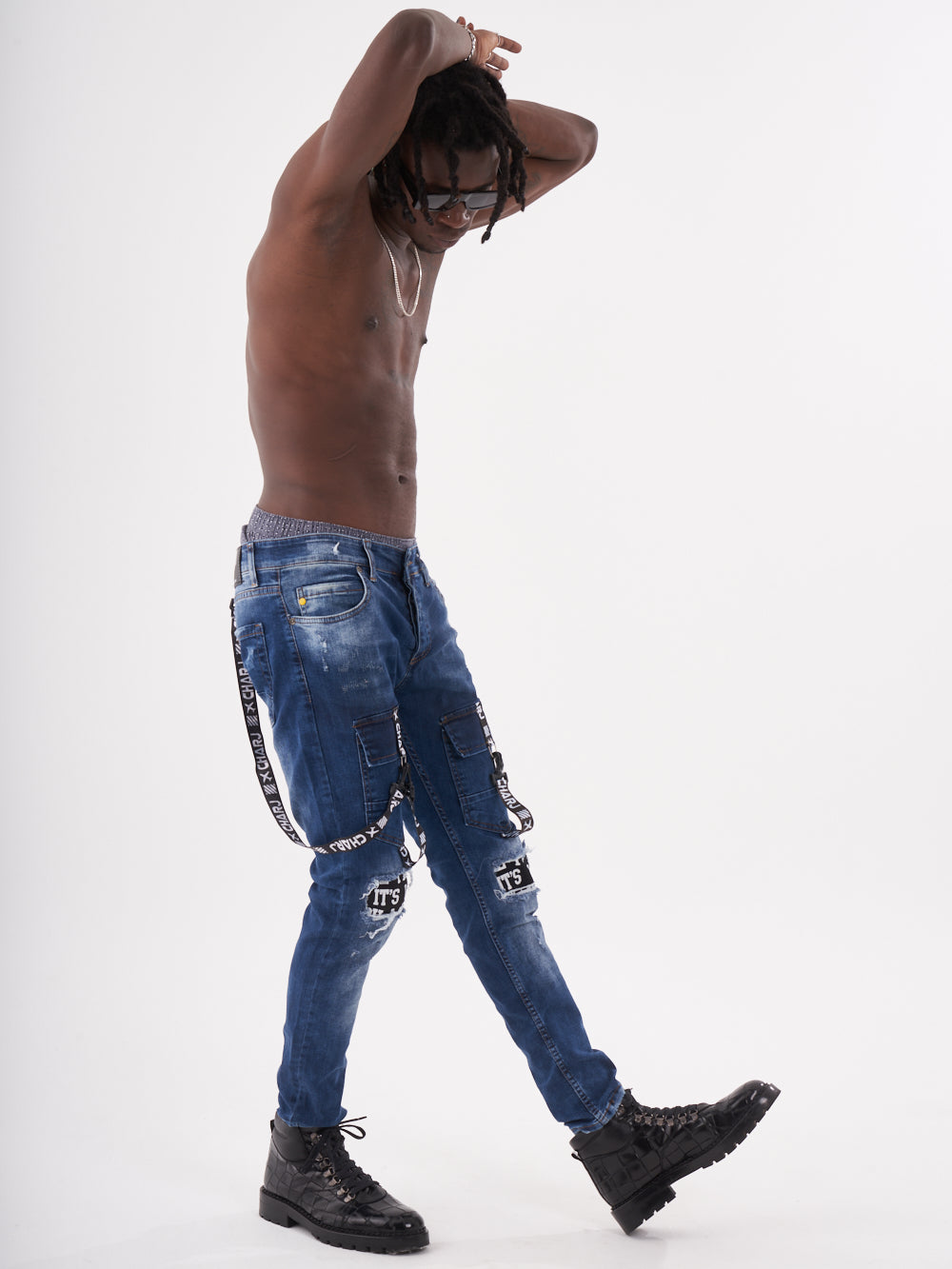 A man in TORNADO BLUE jeans posing in front of a white background.