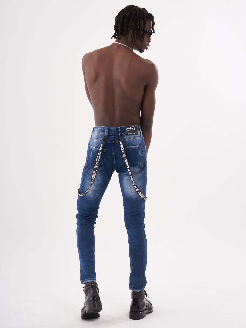 The back view of a man wearing TORNADO BLUE with chains.