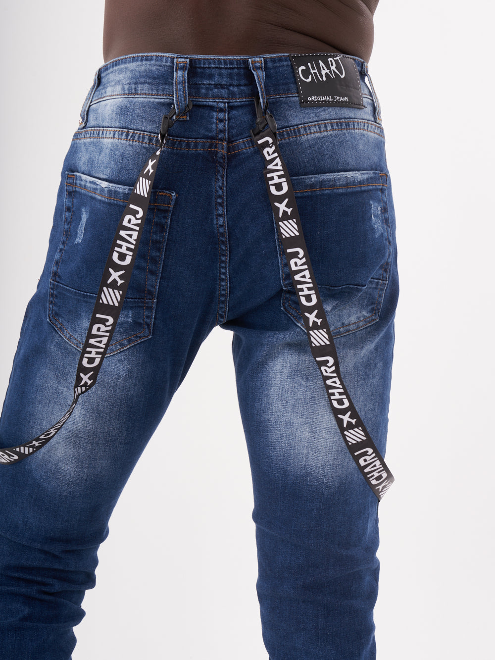 The back of a man wearing TORNADO BLUE jeans with a belt.