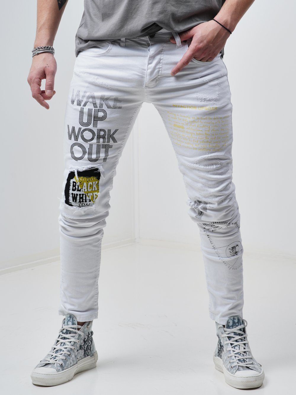 Man wearing Skinny-fit Ripped Jeans called WINGMAN in white color by SERNES Streetwear