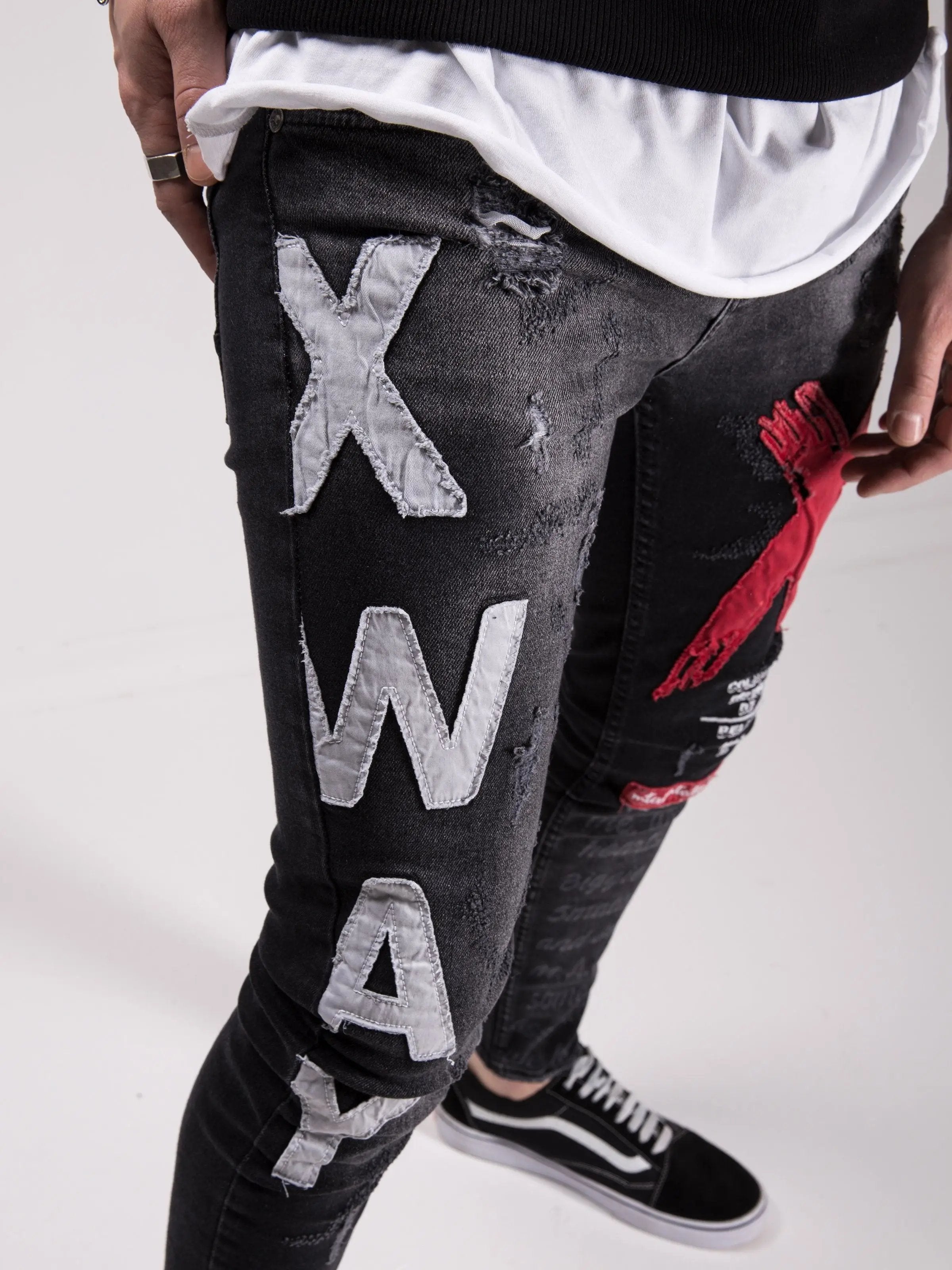A man wearing a pair of MAD DOG skinny fit jeans with the word xway written on them.