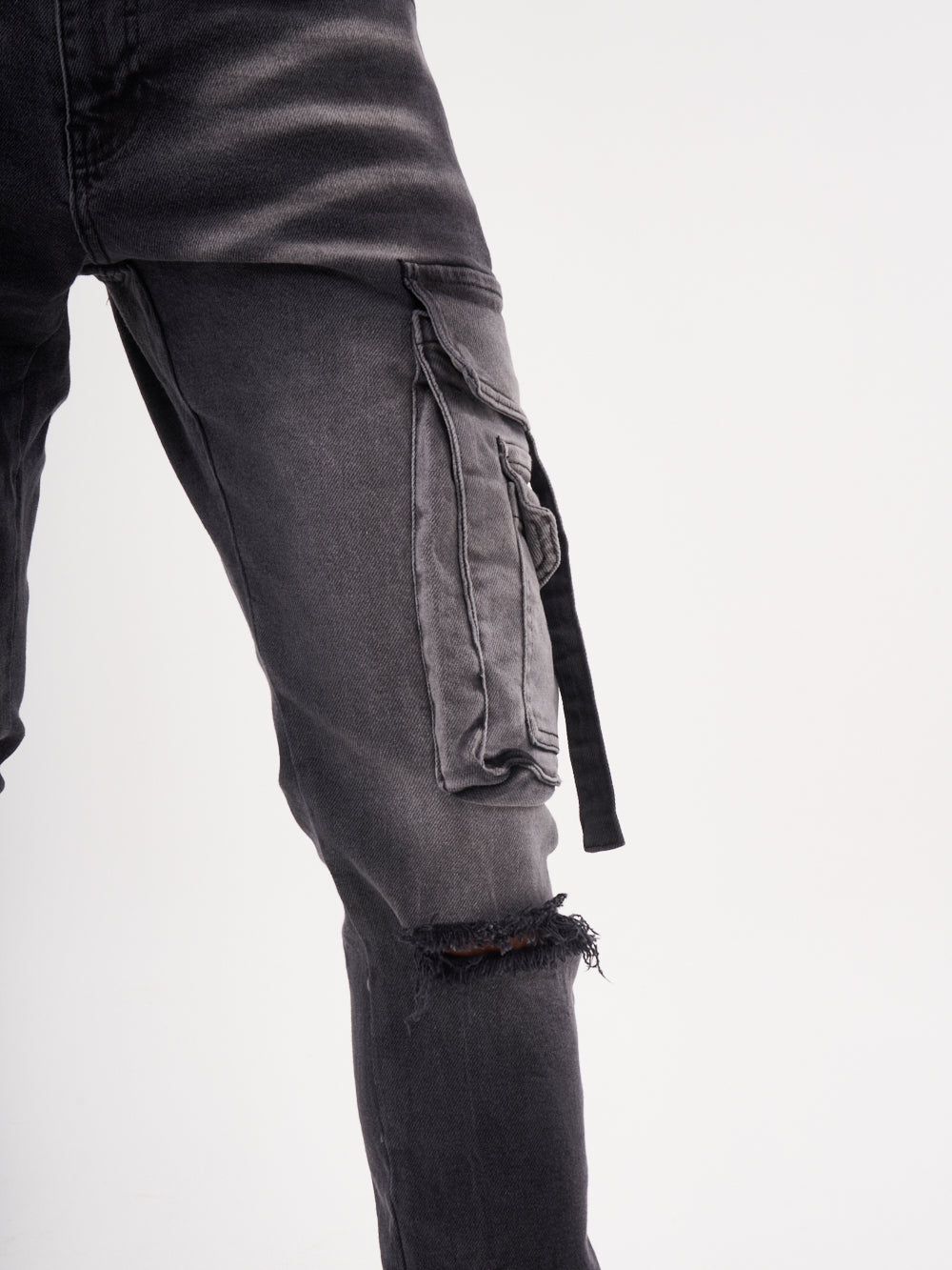 A man wearing HIPSTER cargo pants with ripped knees.