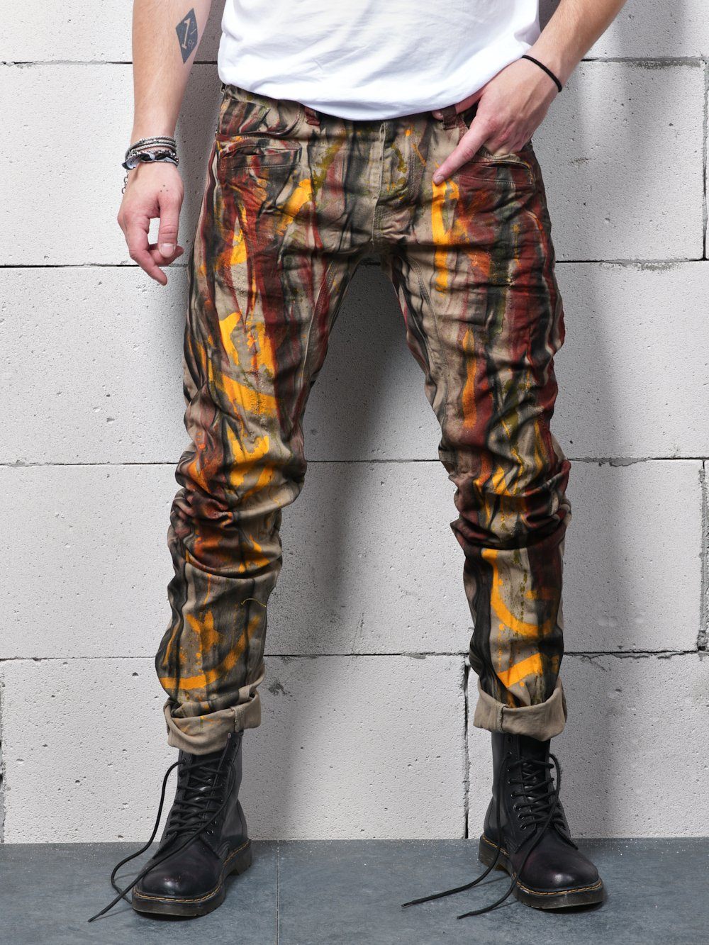 A man wearing a pair of MEXICO streetwear jeans in camouflage.