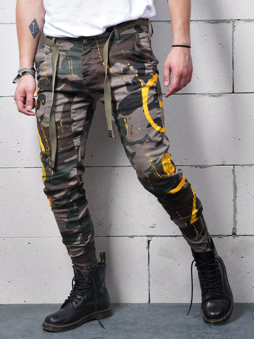 A man wearing KONGOS cargo pants and black boots with a hint of mens streetwear aesthetic.