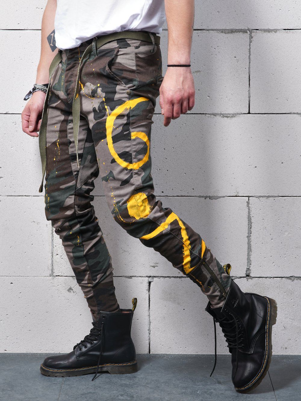 A man wearing a pair of KONGOS skinny fit camouflage jogging pants.