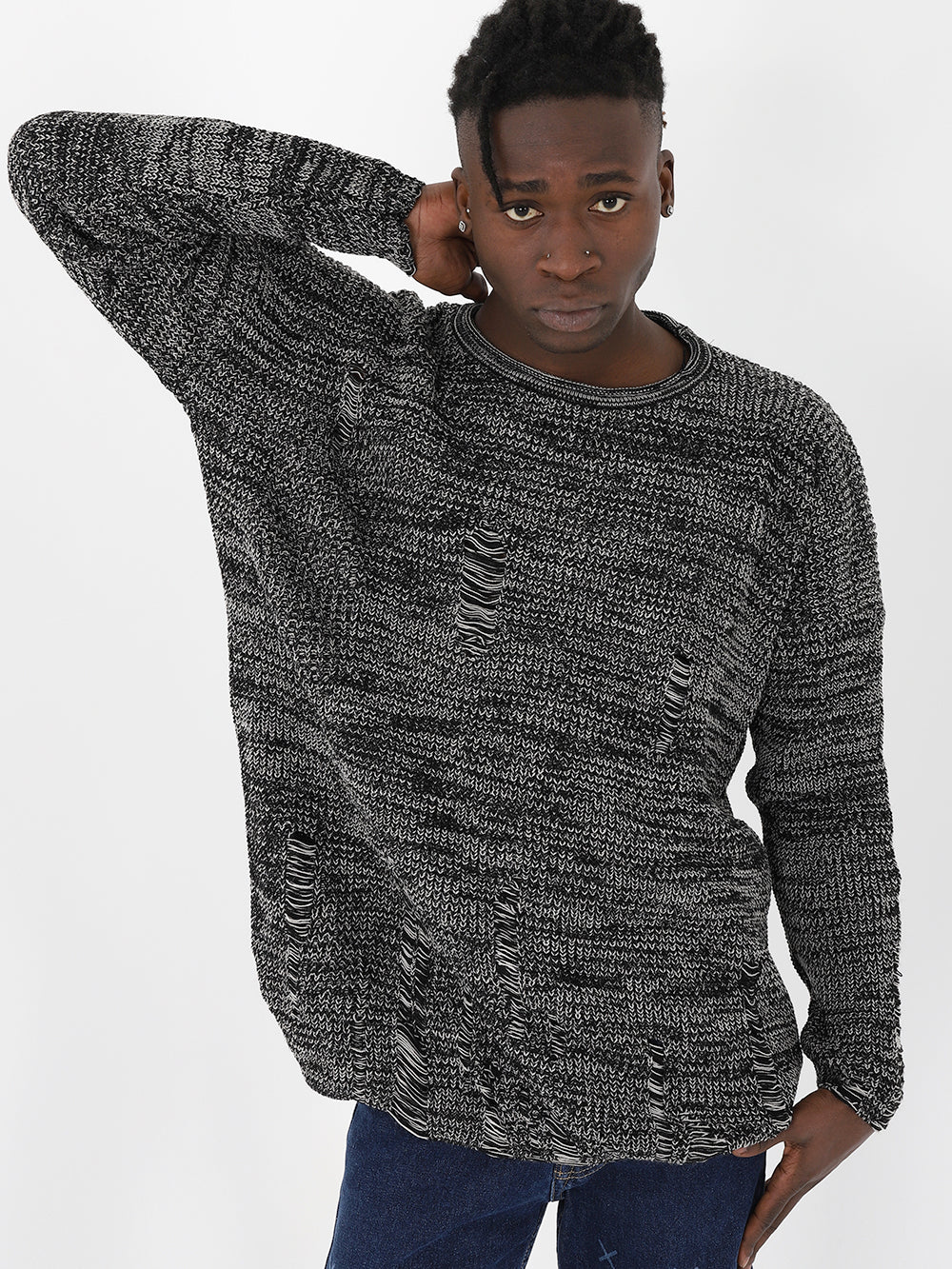 A man in a DISTRESSED GENTLEMAN SWEATER | GRAY, true to size fit, is posing for a photo.