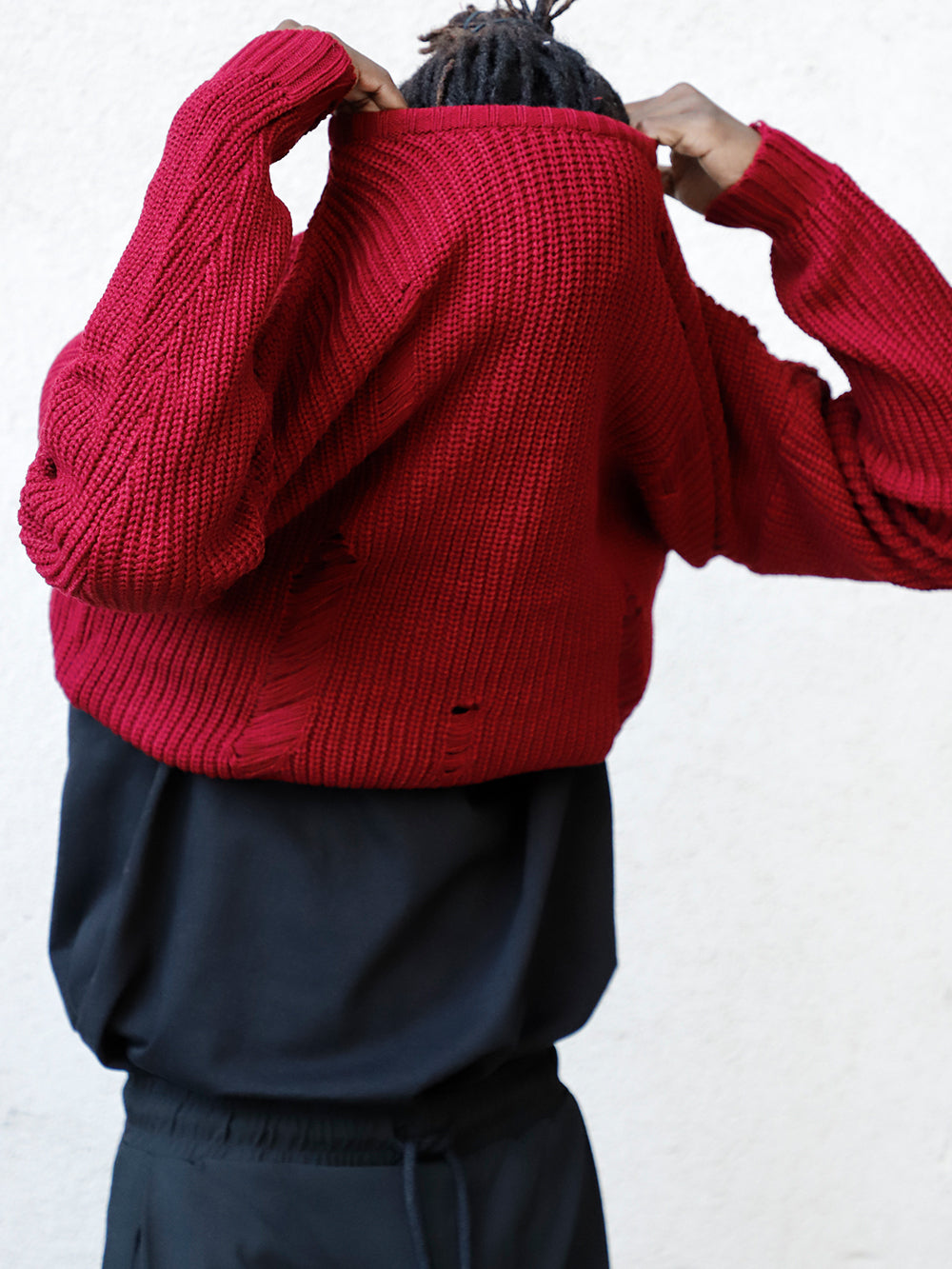 A man wearing a Distressed Gentleman Sweater | Burgundy.