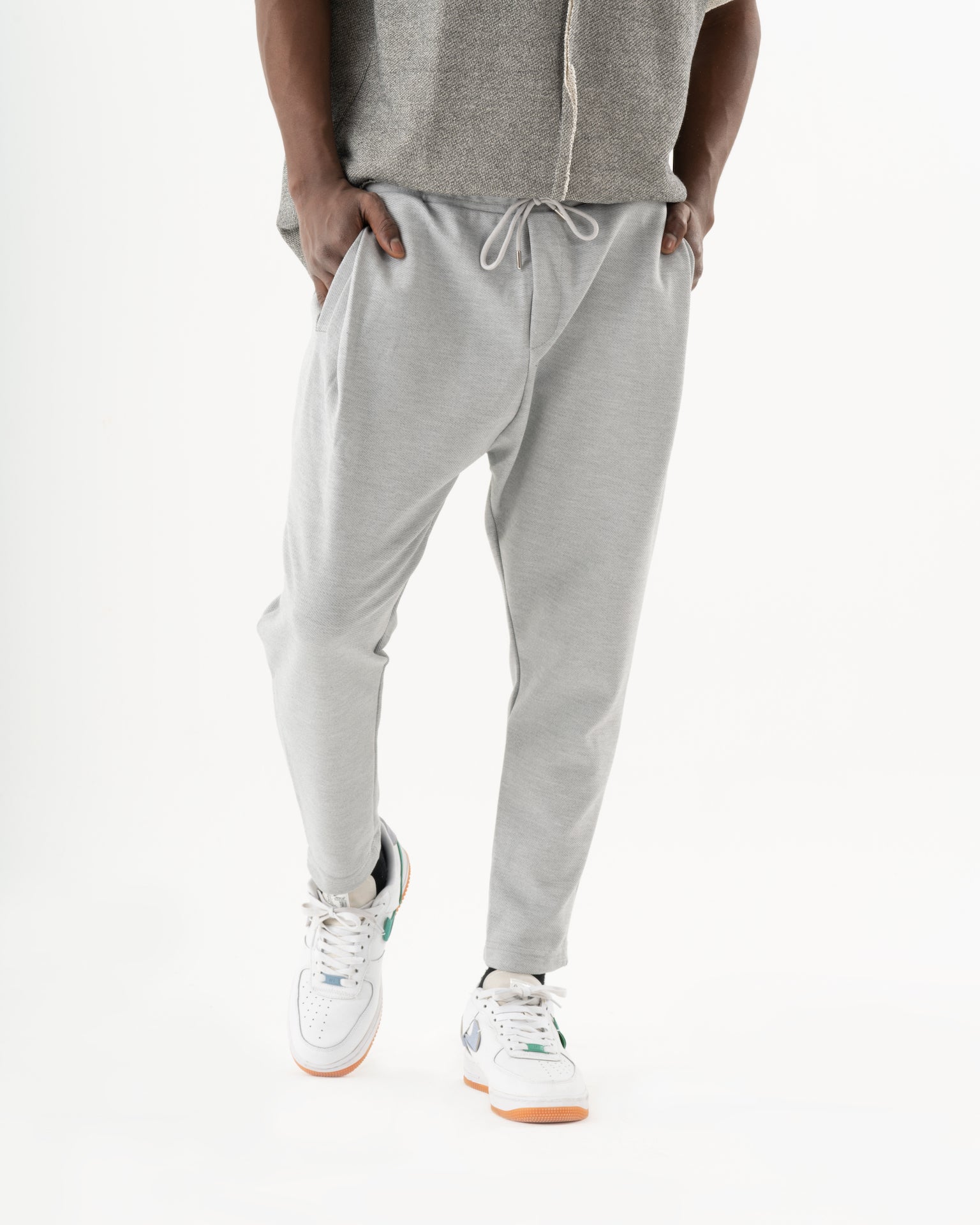 A man in a comfortable fit grey sweatshirt and SERENE JOGGERS.