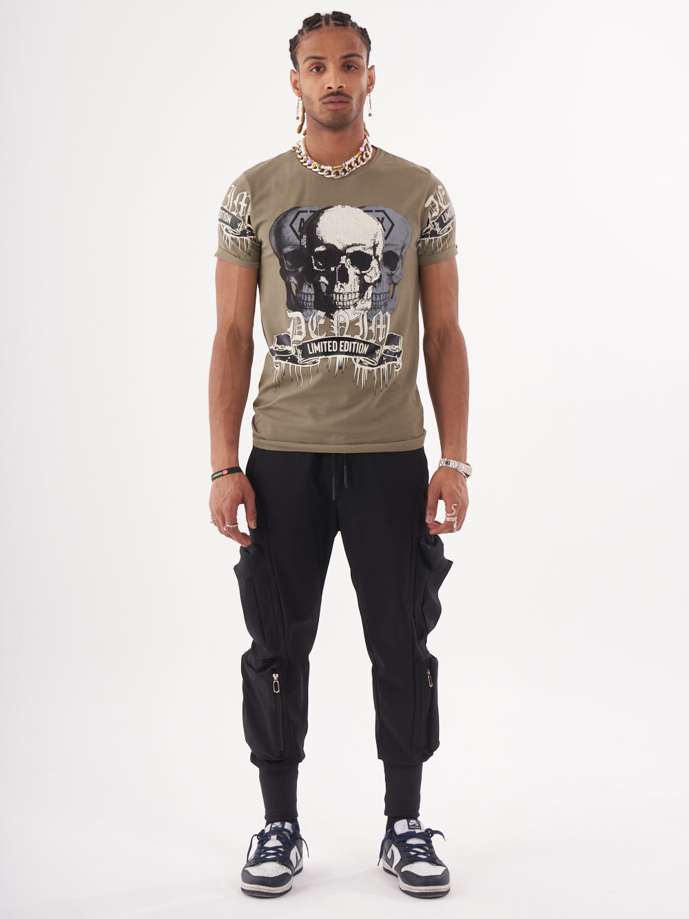 A man wearing the SKULL CRUSHER T-SHIRT | GREEN with a skull on it.