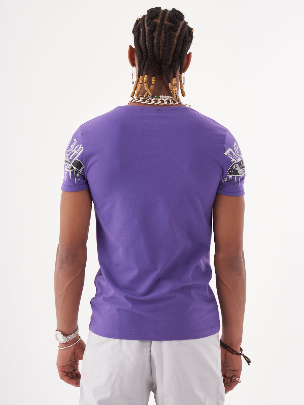The back view of a man wearing a SKULL CRUSHER T-SHIRT | PURPLE.