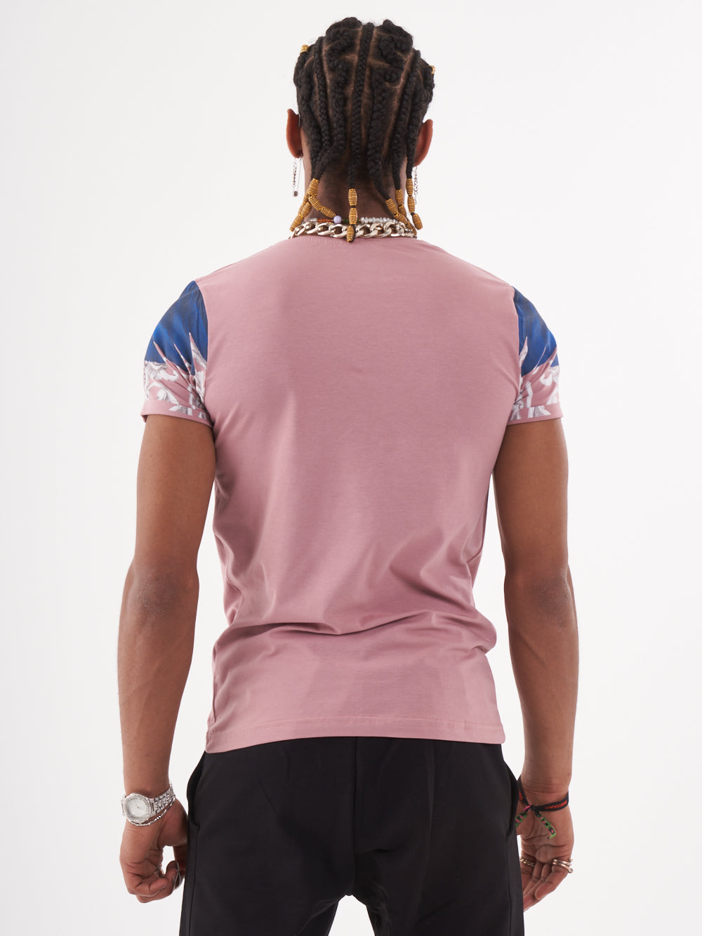 The back view of a man wearing a EUPHORIA T-SHIRT | MAUVE featuring a skeleton print.