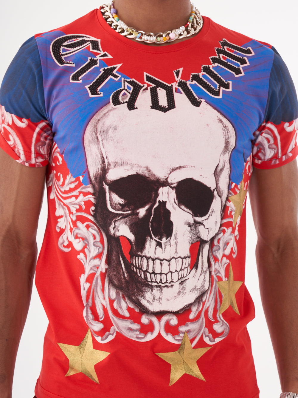 A man wearing an EUPHORIA T-SHIRT | RED with a skull and stars print.