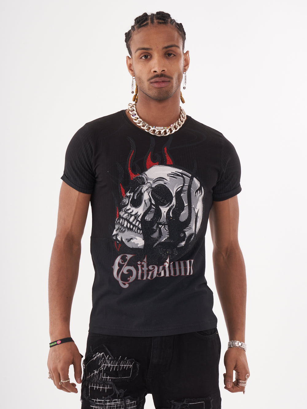 A man wearing a NIRVANA skull-print embellished T-SHIRT in BLACK, paired with black patched jeans by SERNES