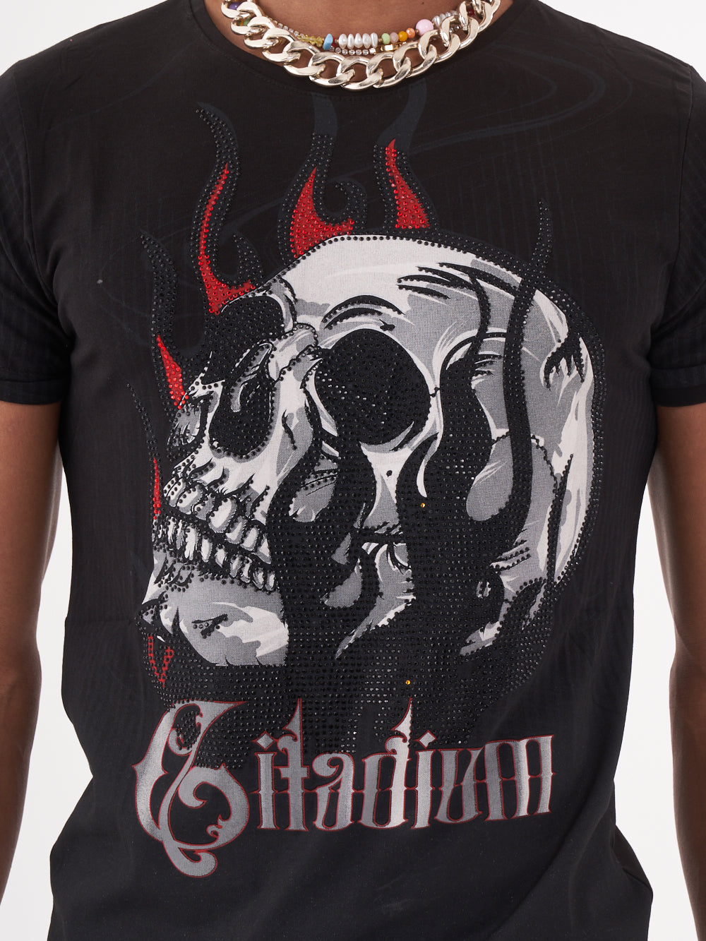 Close up shot of a man sporting a NIRVANA skull-print embellished t-shirt