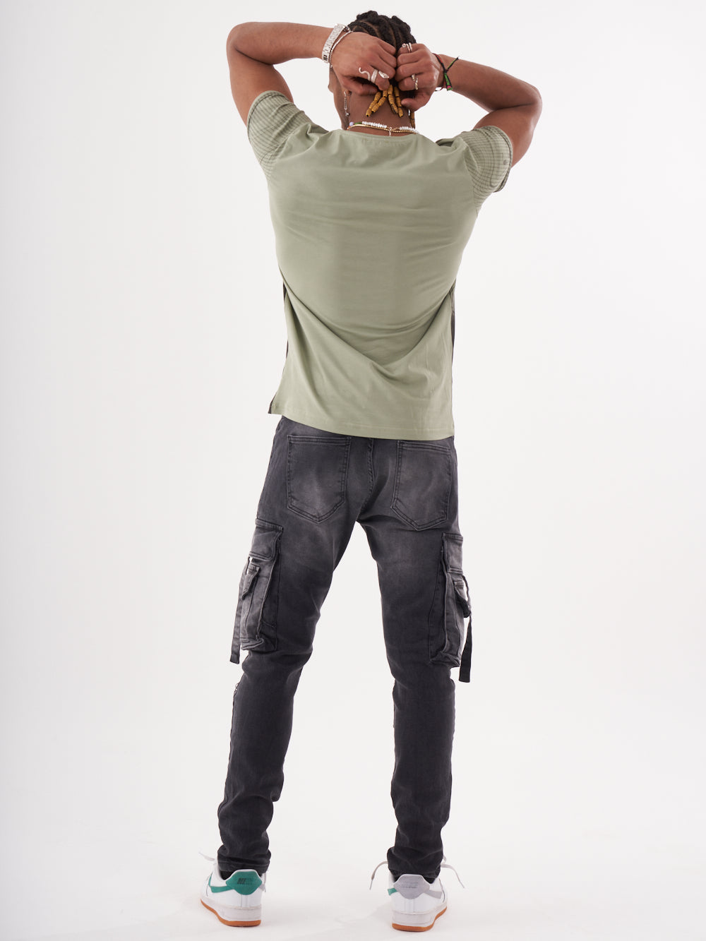 A man wearing cargo pants and a NIRVANA T-SHIRT | GREEN.