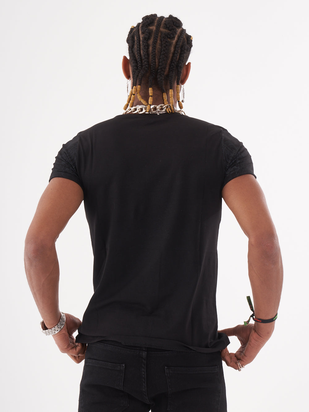 The back of a man wearing a TRINITY T-SHIRT | BLACK tee.