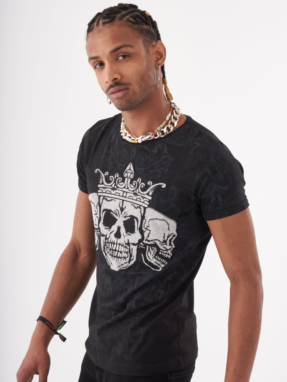 A man wearing a TRINITY T-SHIRT | BLACK with a skeleton print on it.