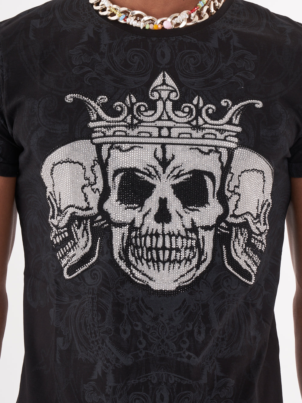A man wearing a TRINITY T-SHIRT | BLACK with skeleton print.