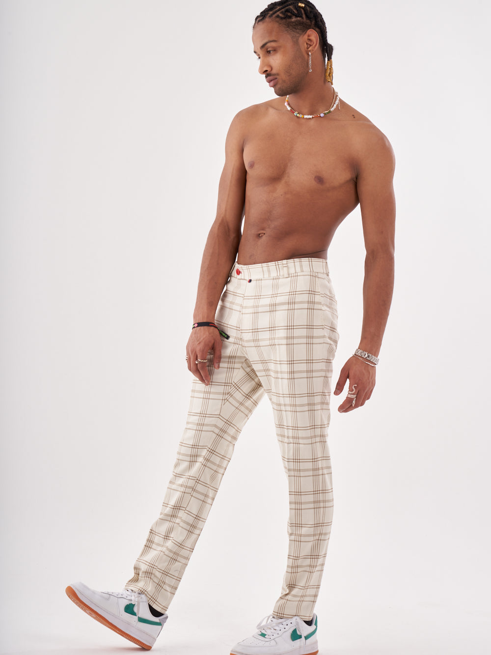 A man in FULLMOON PANTS posing in front of a white background.