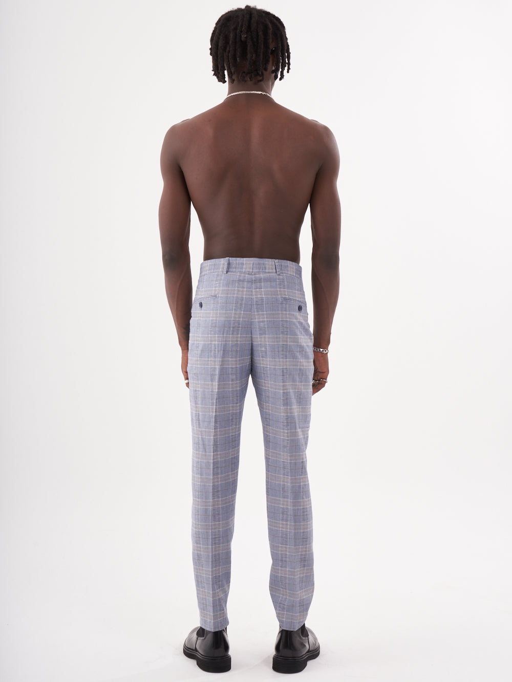 The back view of a man wearing MORAINE PANTS.