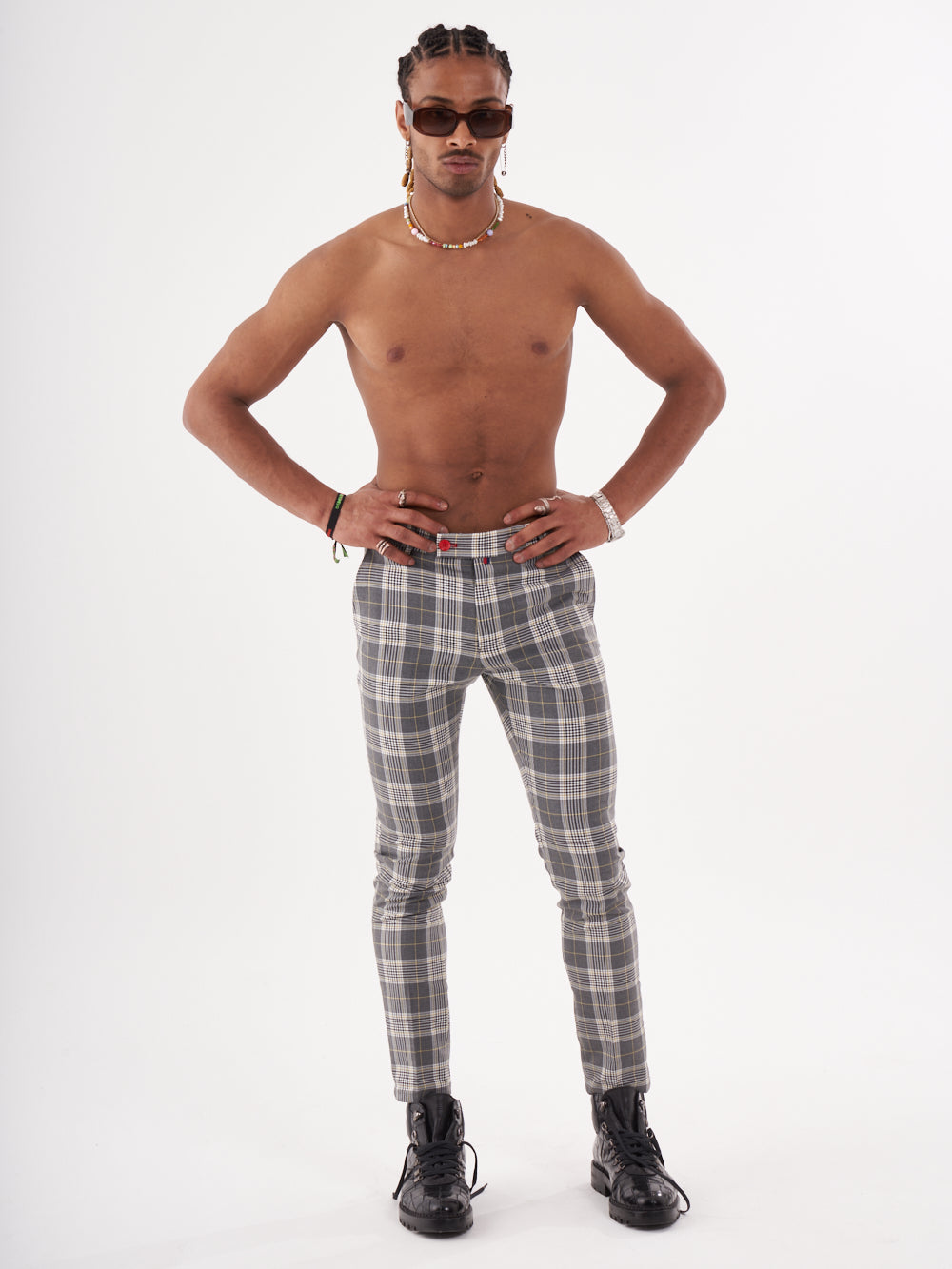A man is posing for a photo in a grey Checkmate pants.