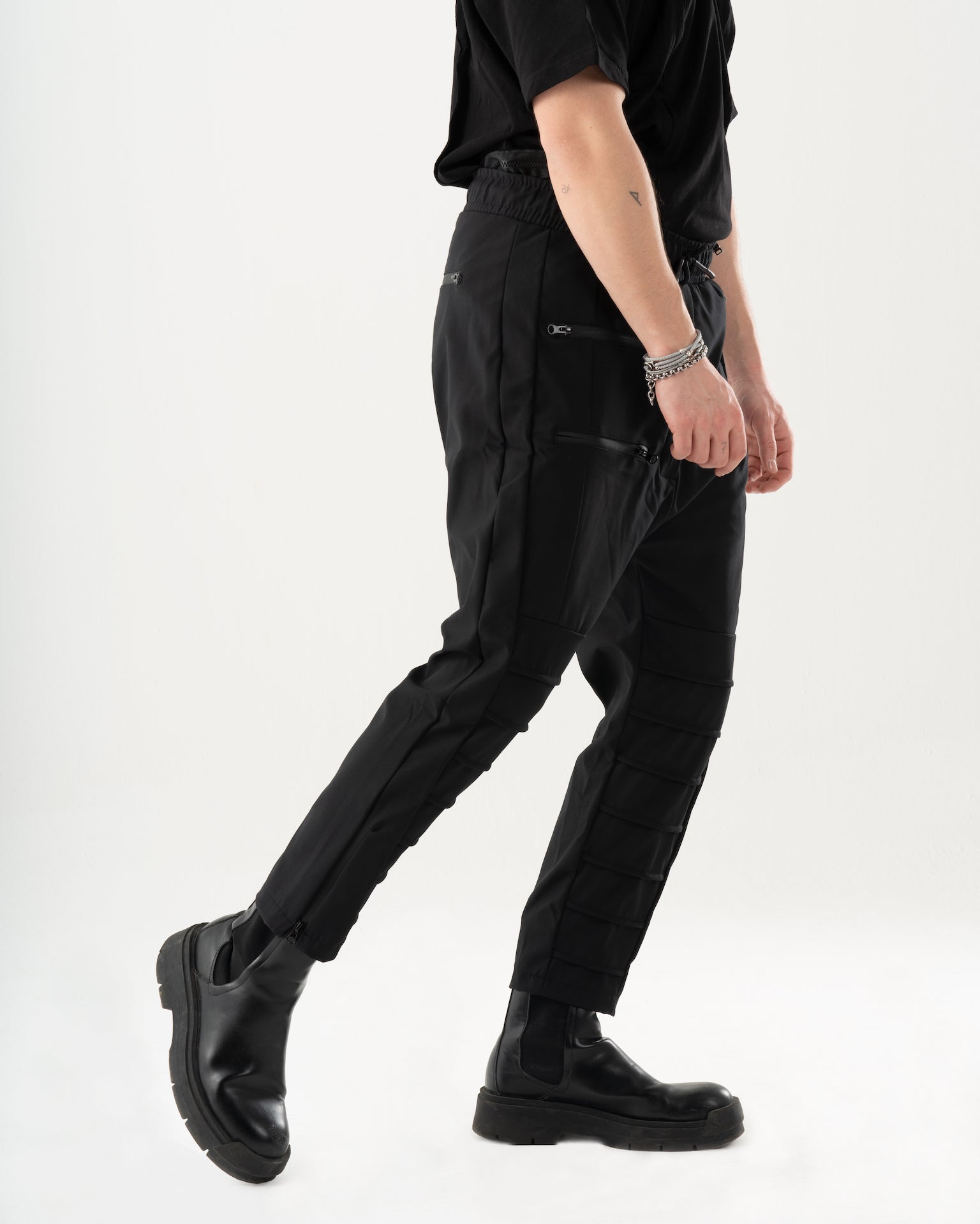 A man wearing INVOGUE JOGGERS and a black t - shirt.