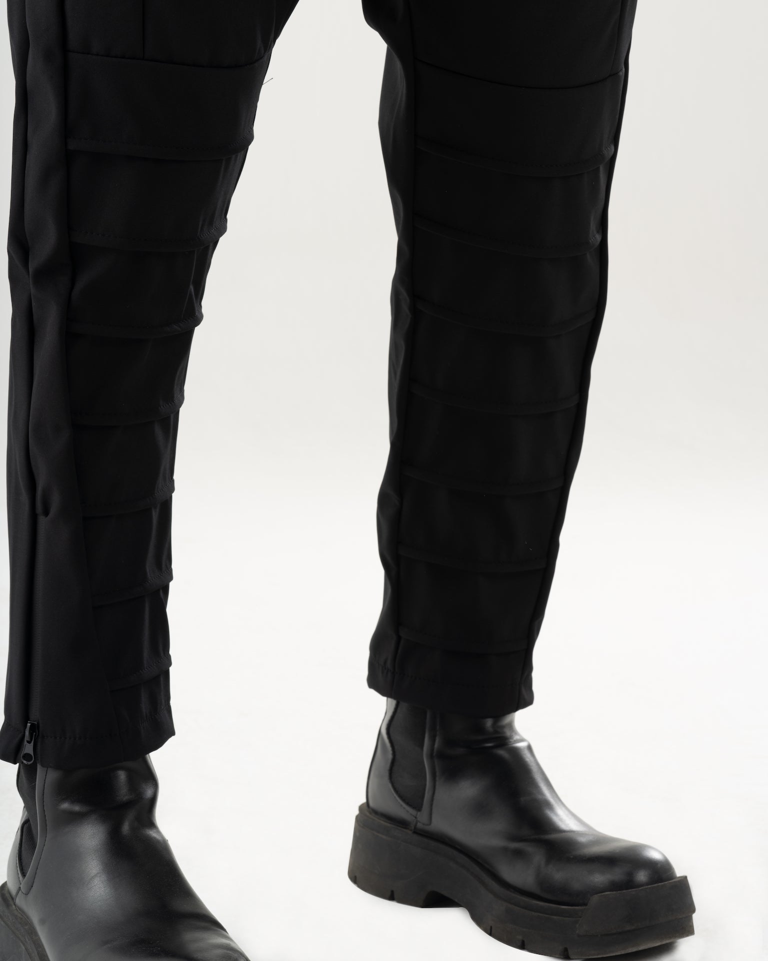 A man wearing INVOGUE JOGGERS and black boots.
