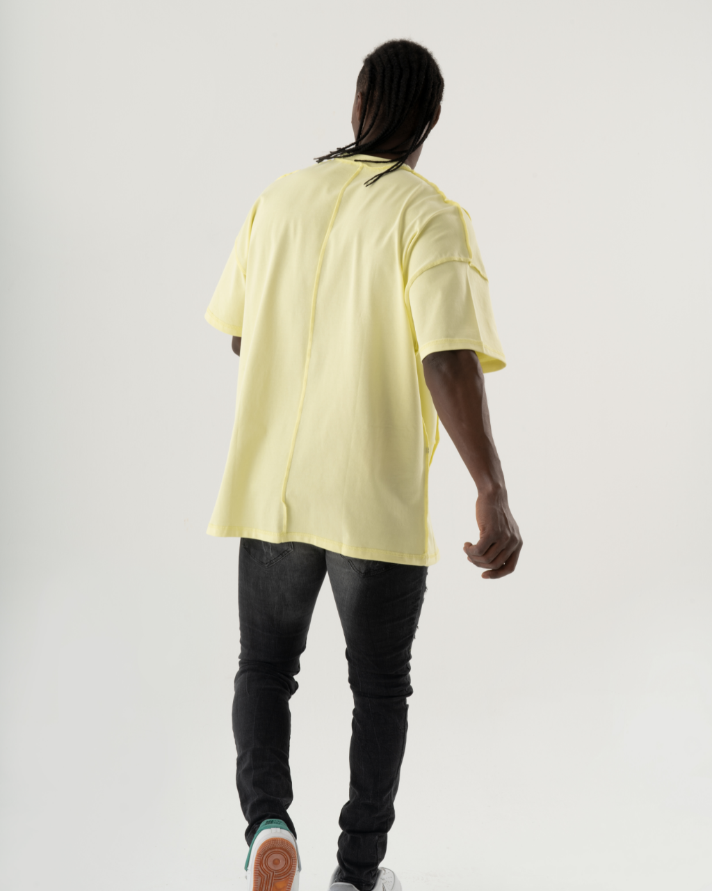 A casual man wearing a summery yellow MENTALIST T-SHIRT | LIME and black sneakers.
