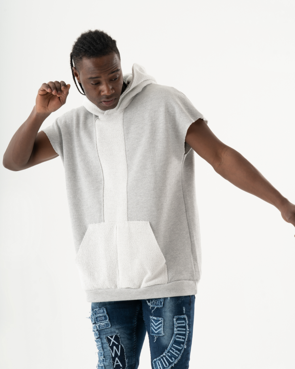 A man wearing a BACHELOR HOODIE | WHITE with a pouch pocket.