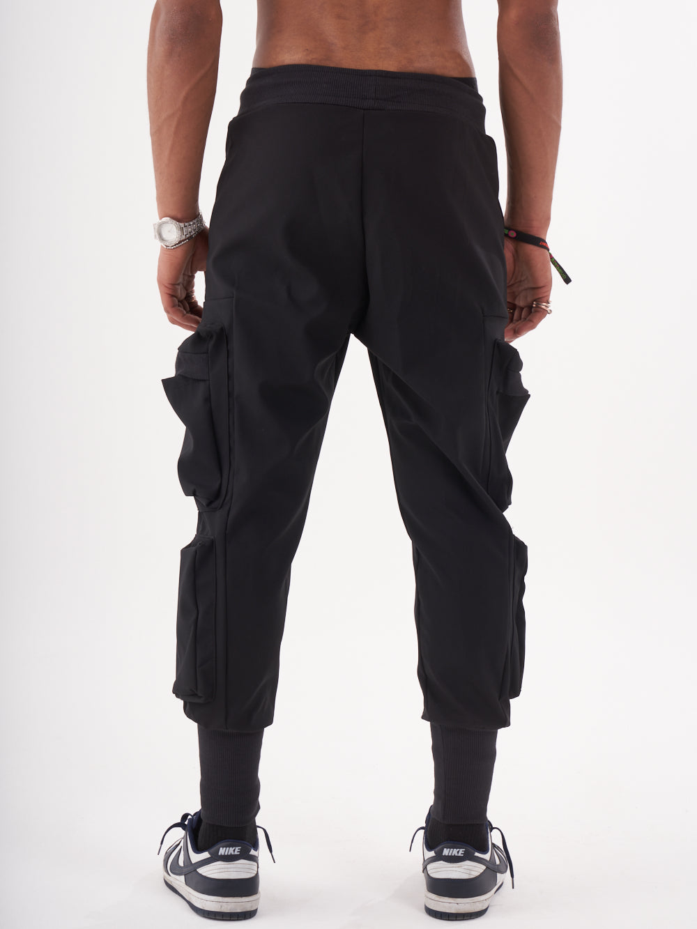 The back view of a man wearing OUTLIER JOGGERS | BLACK.