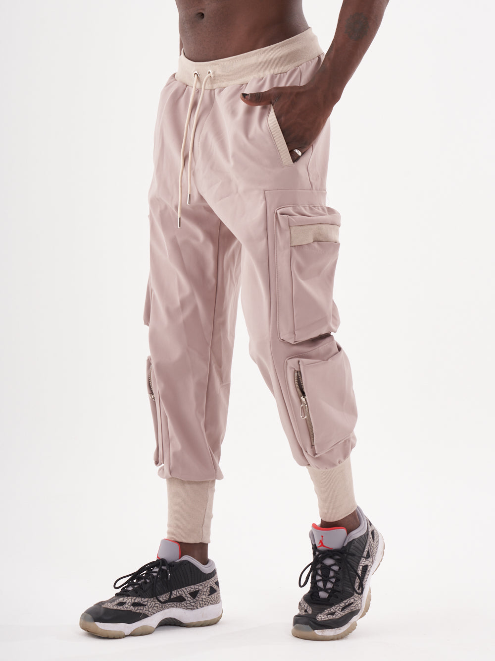 A man wearing OUTLIER | MAUVE cargo jogger pants.