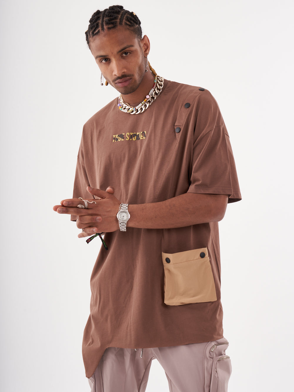 The model is wearing a brown BEATNIK T-SHIRT with a pocket.