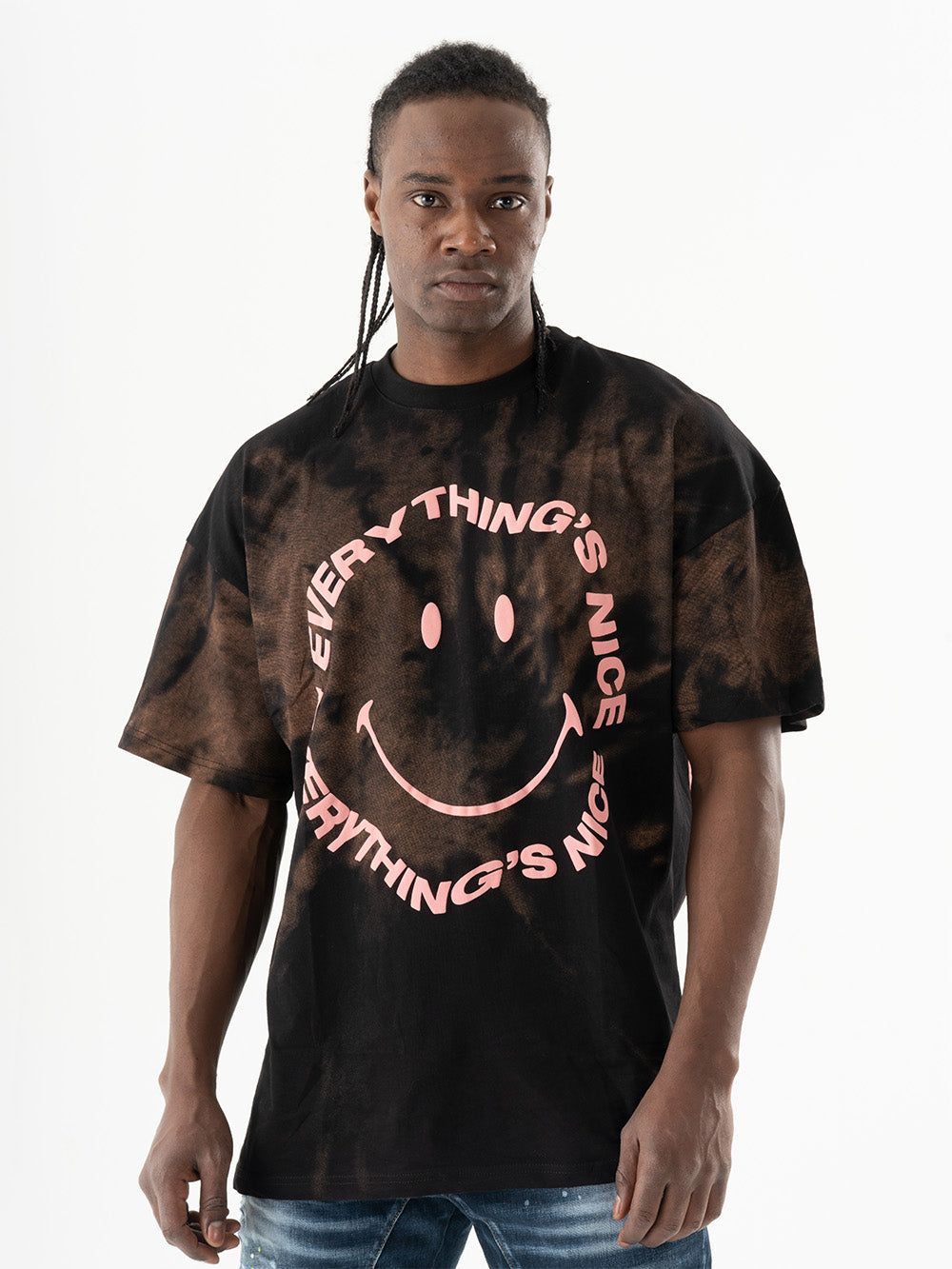 A man wearing an Optimist T-Shirt with a smiley face batik effect.