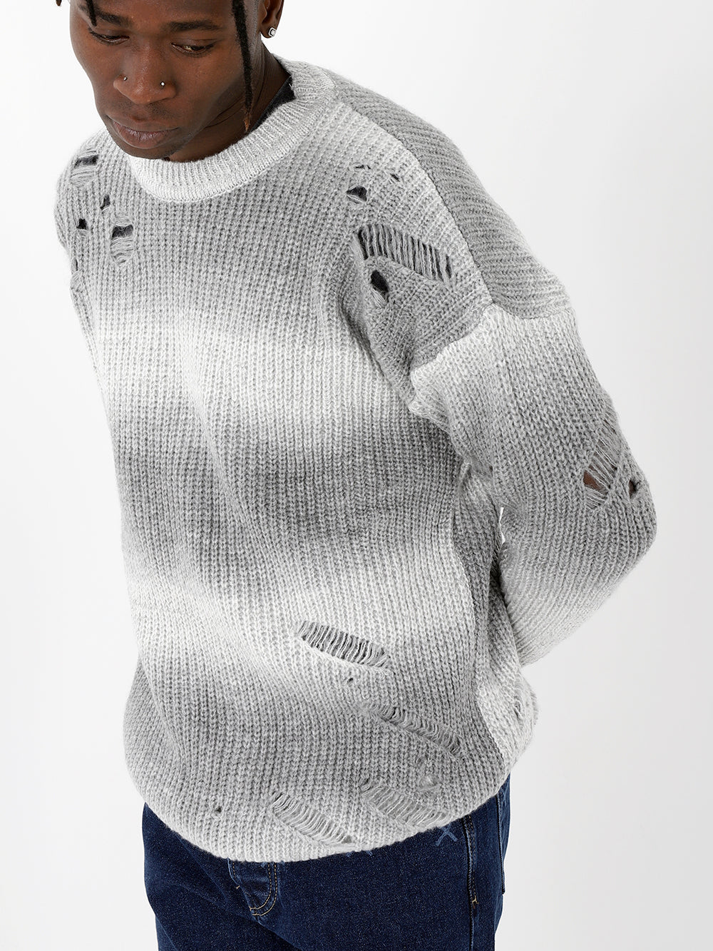 A man wearing a DISTRESSED GENTLEMAN SWEATER | WHITE-GRAY sweater.