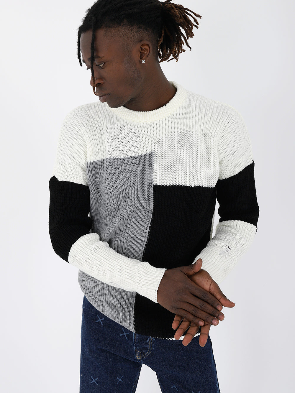 A man wearing a DISTRESSED GENTLEMAN SWEATER | MULTICOLOR made of 100% acrylic material.