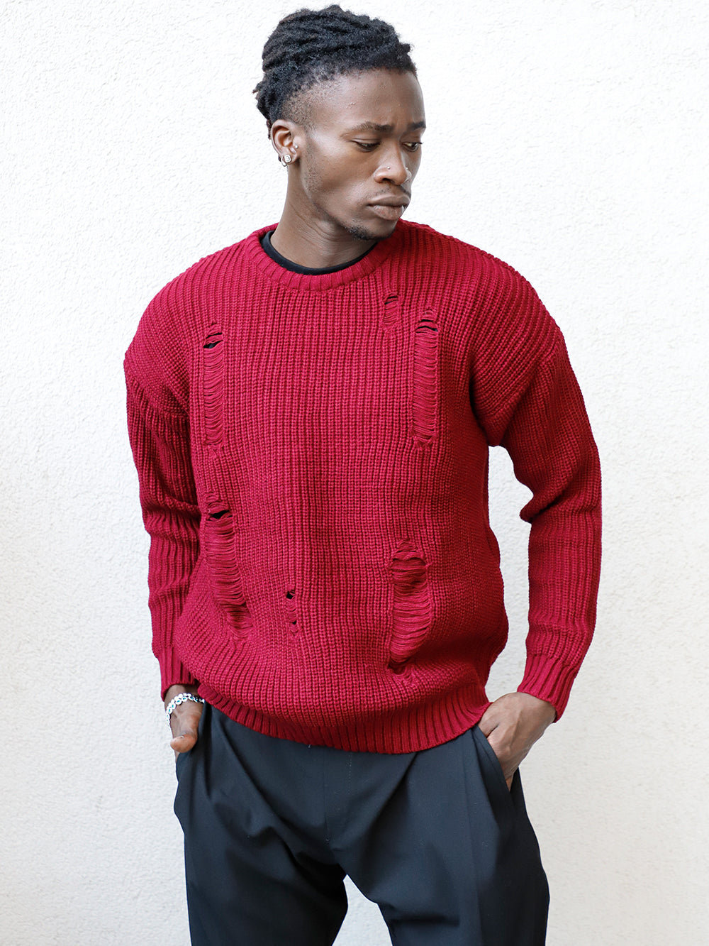 A fit man wearing a DISTRESSED GENTLEMAN SWEATER | BURGUNDY and black pants.