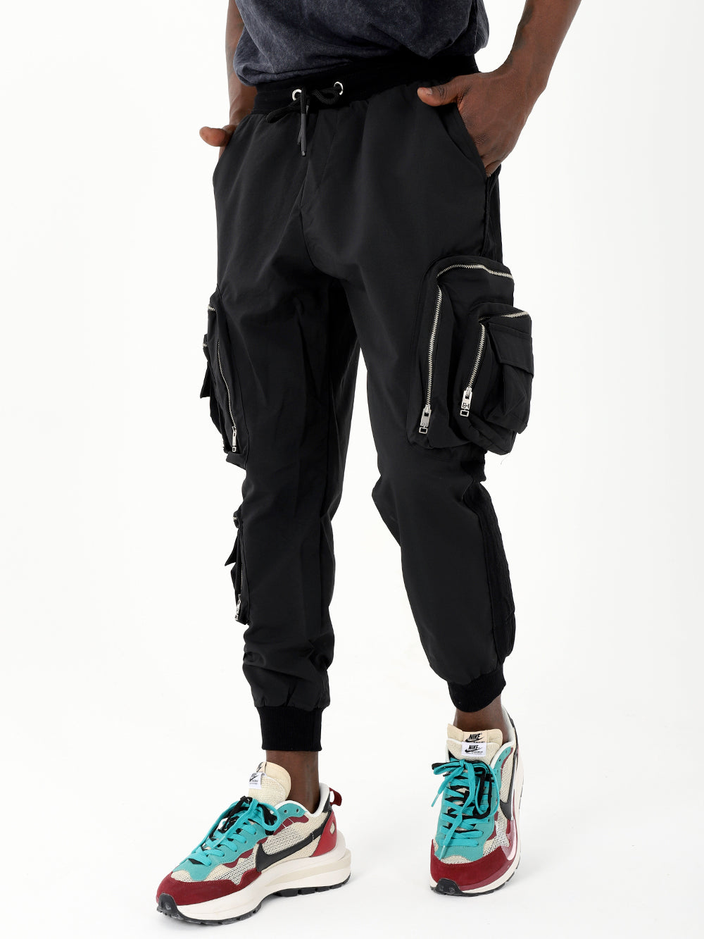 A man wearing black LAVANO JOGGERS and sneakers.