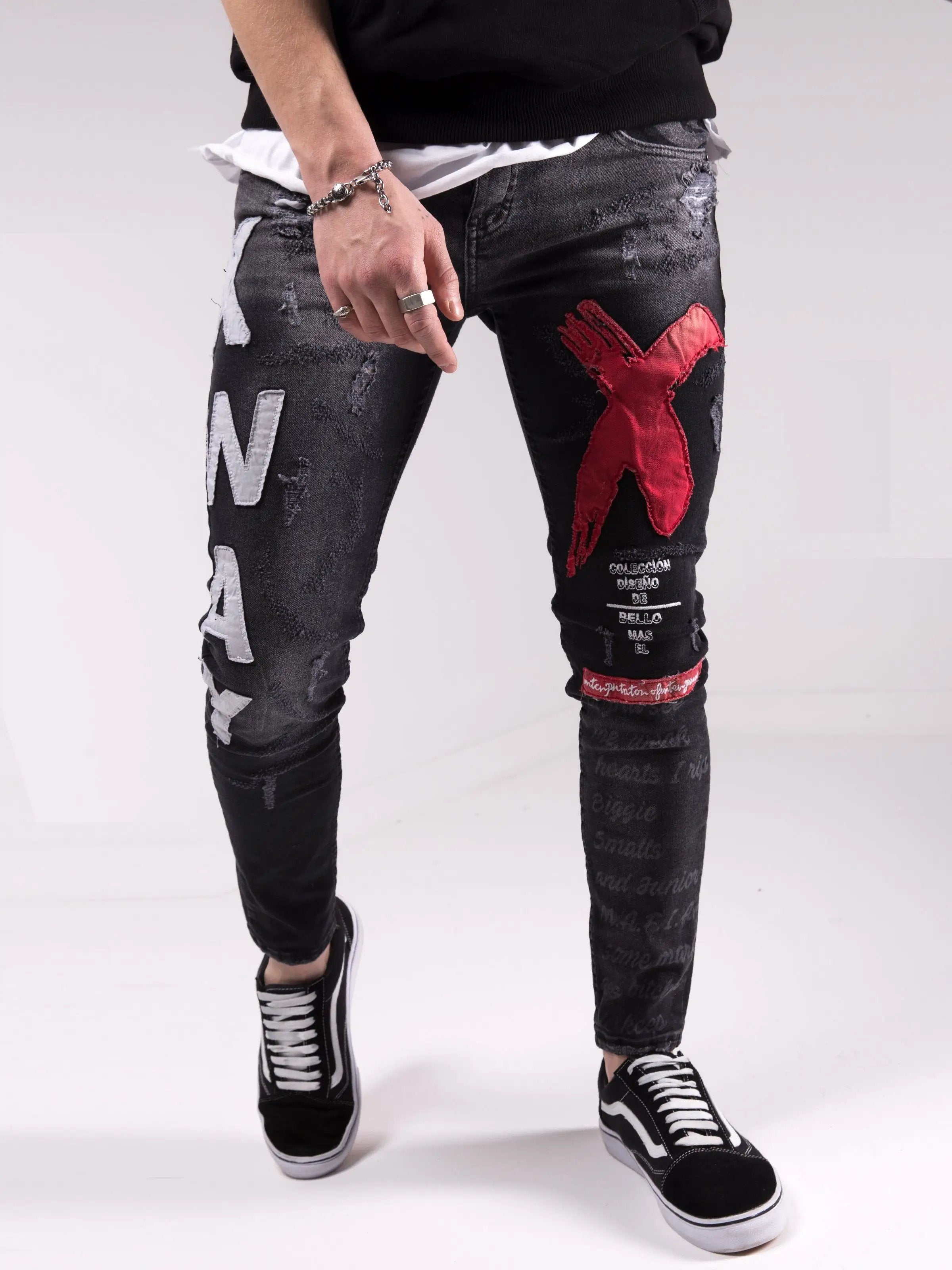 A man wearing a pair of MAD DOG skinny fit black jeans.